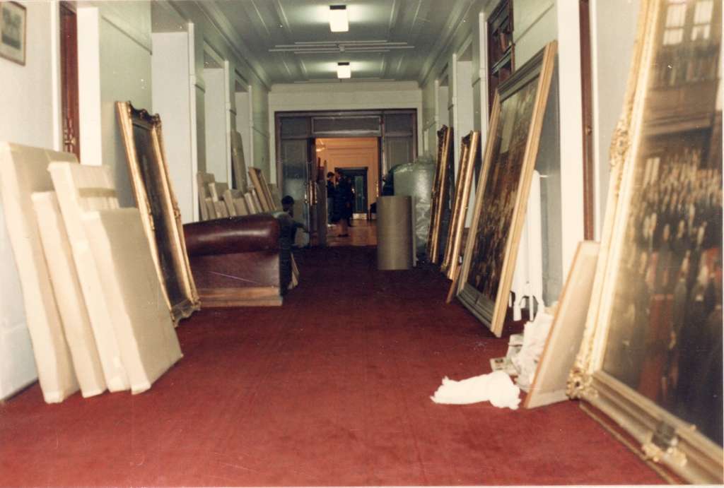 The Senate Government Lobby hallway, with large framed paintings leaning against the wall in preparation for packing and relocation.