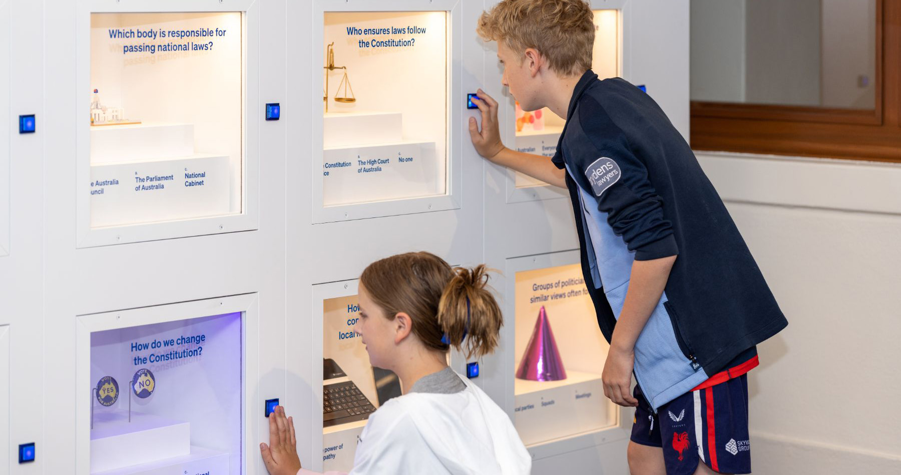 Visitors interacting with the exhibition