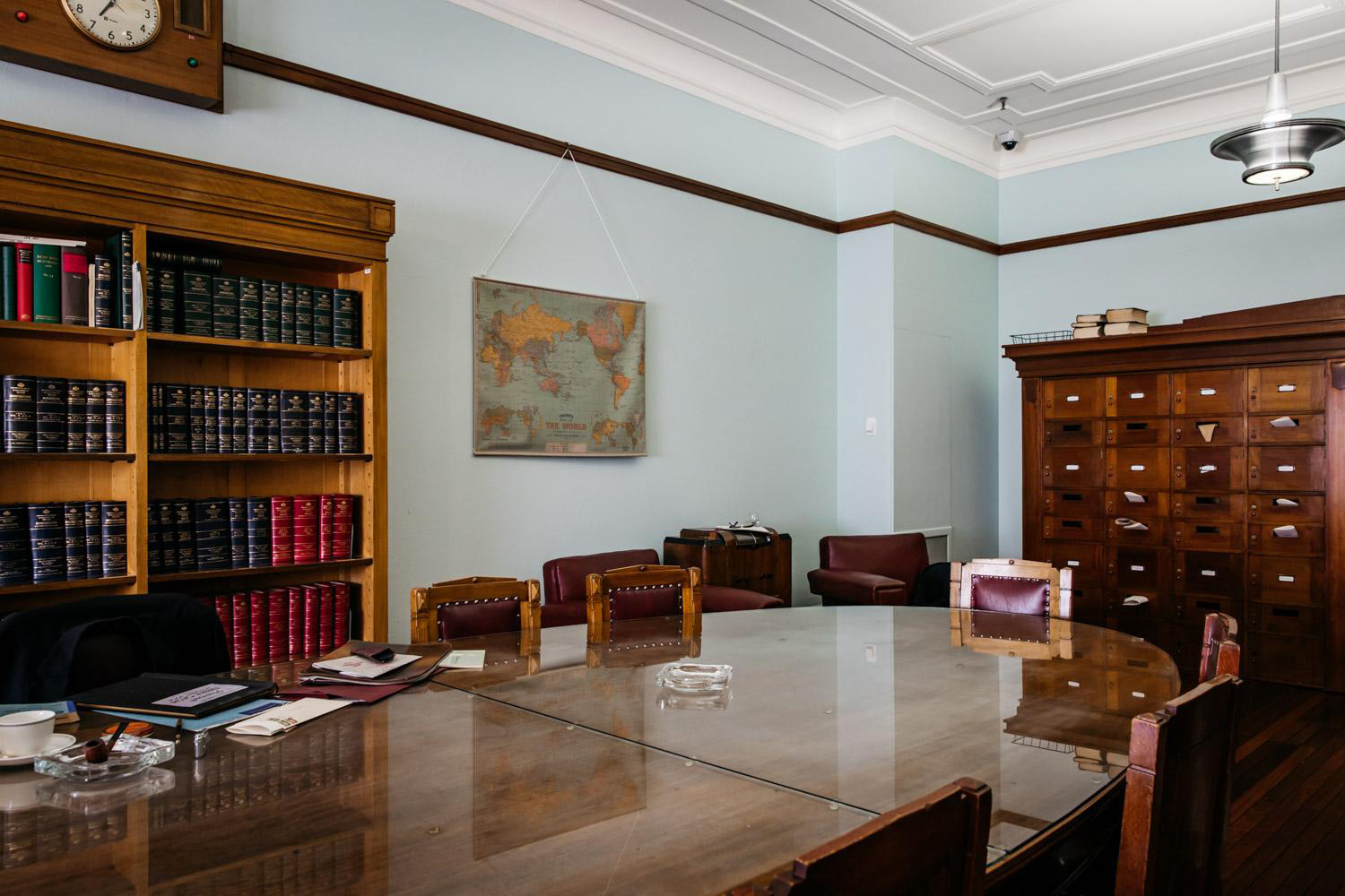 A modern-day view of the Country Party Room. A large, varnished wooden table with a rounded end takes up the majority of the room, with chairs around it. There is a wooden bookcase on the wall to the back, then a unit of drawers against the wall at the end. A modern-day view of the Country Party Room. A large, varnished wooden table with a rounded end takes up the majority of the room, with chairs around it. There is a wooden bookcase on the wall to the back, then a unit of drawers against the wall at the end.
