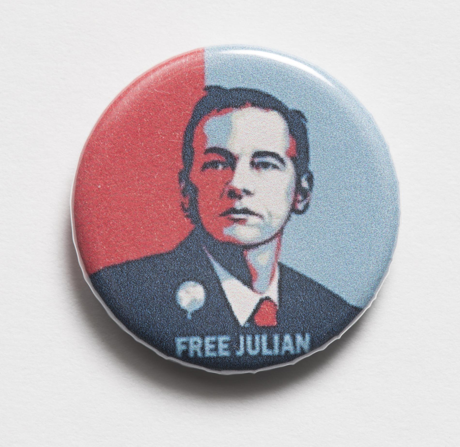 Photograph of a small badge labled "Free Julian"