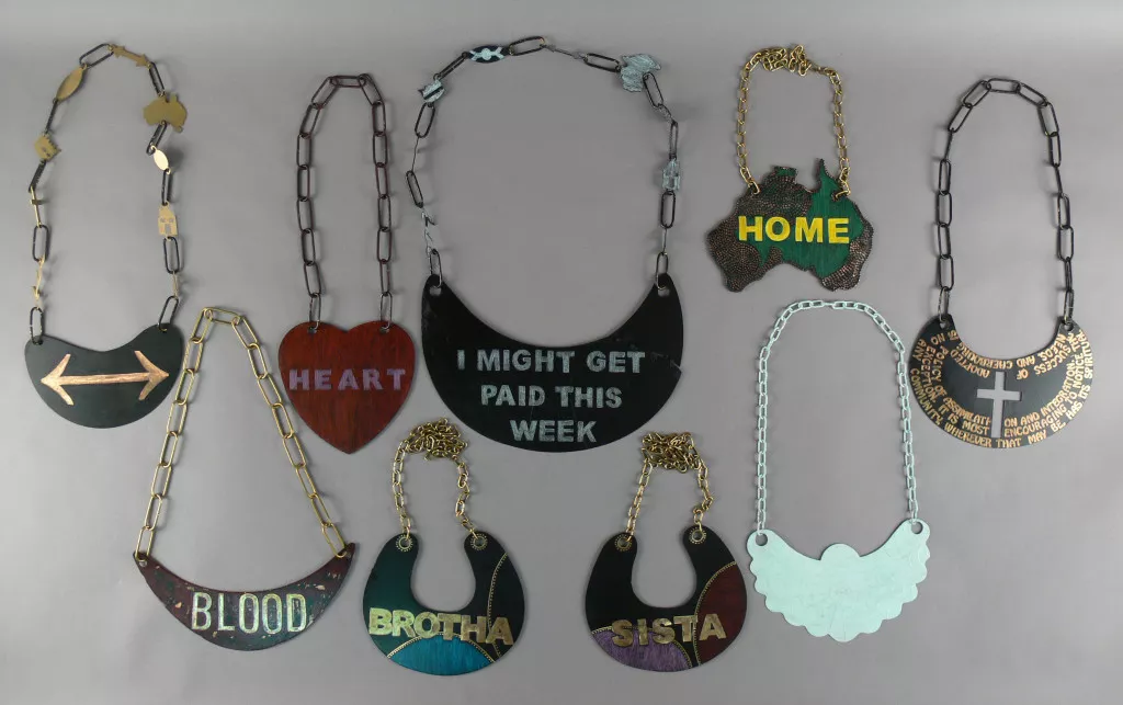 A collection of handmade breastplates, decorated with words and colours that reflect modern topics, styles and ideas.