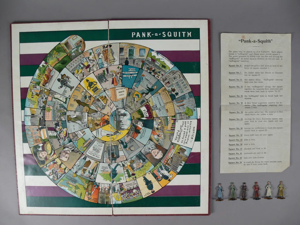 A board game, entitled 'Pank-a-Squith', showing an illustrated spiral pathway into the centre, and player figurines in the shape of suffragettes