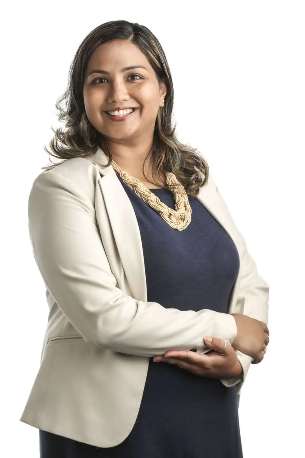 A woman, Ruchika Rawat, smiling and wearing a light blazer over a blue dress.