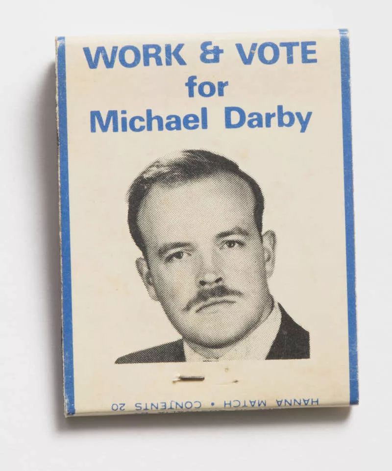 Photograph of a matchbook with a mans face on it. Photograph of a matchbook with a mans face on it.