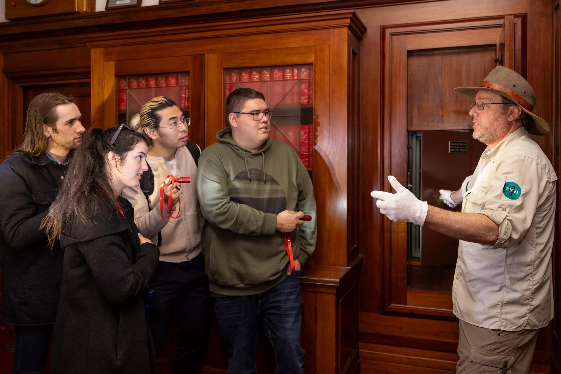 Tim the Yowie Man showing a tour group a room in Old Parliament House.