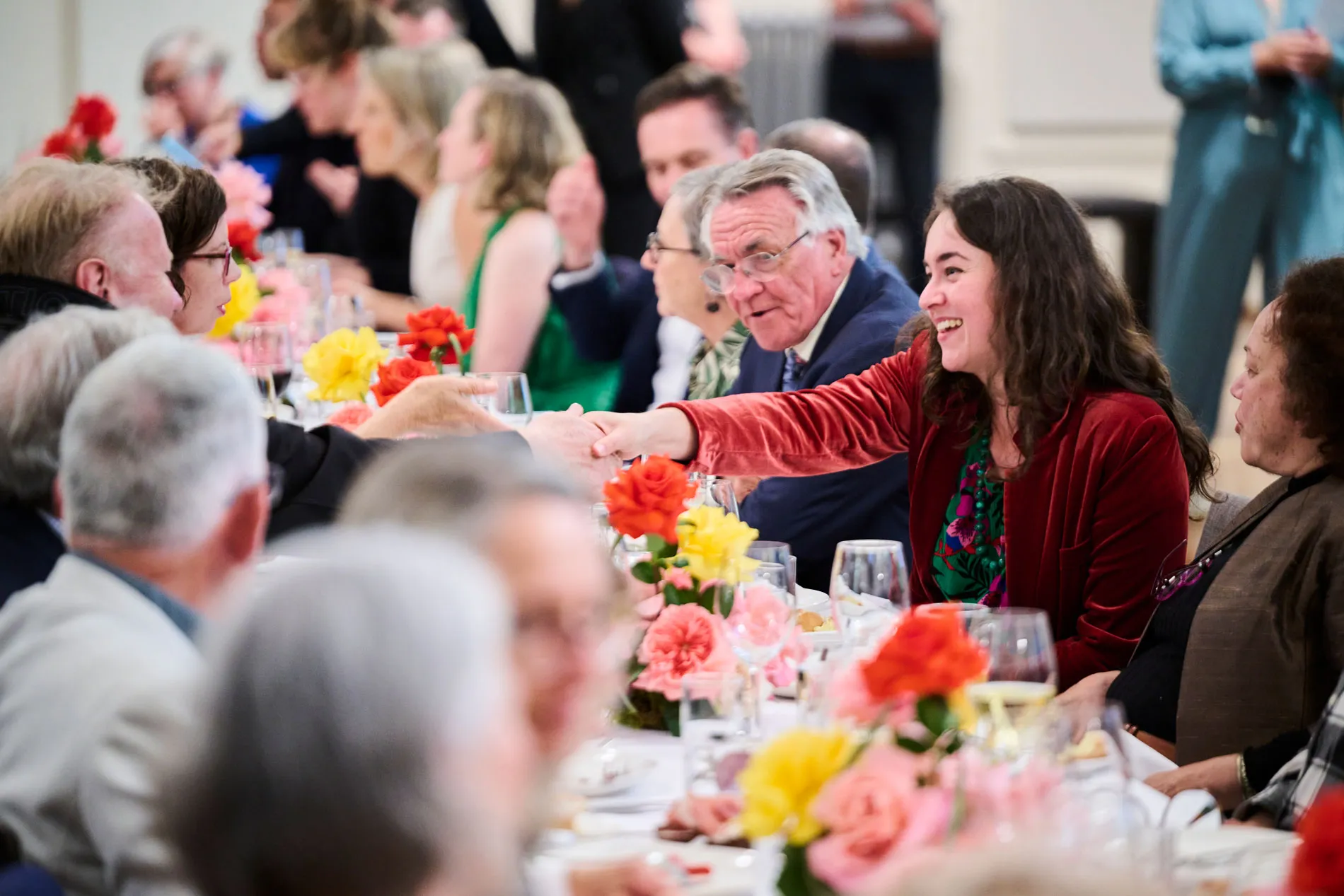 People seated at a table decorated with flowers at Old Parliament House.