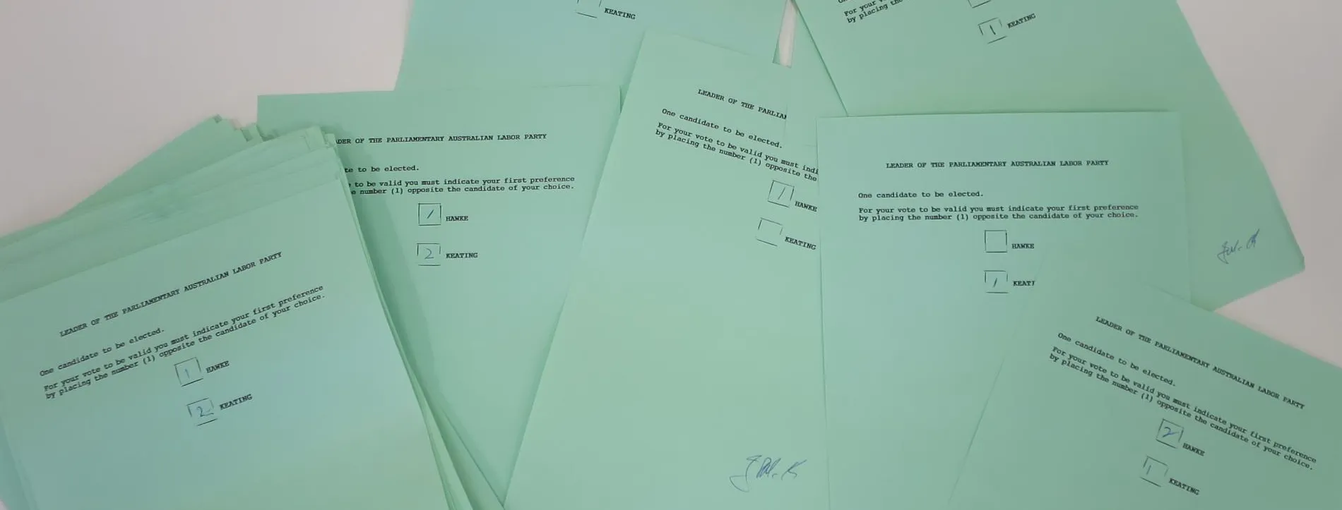 A pile of green ballot papers with two names listed: HAWKE and KEATING.