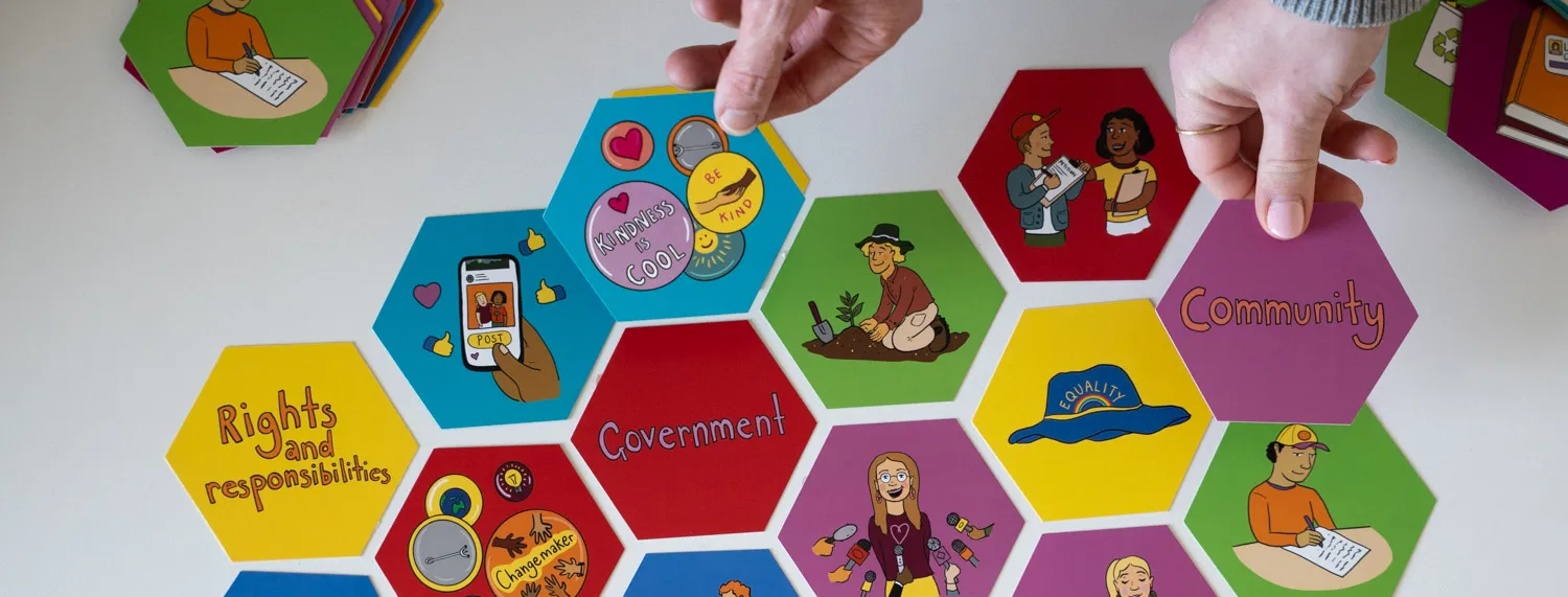 Hexagonal coloured tiles featuring words about civics and democracy.