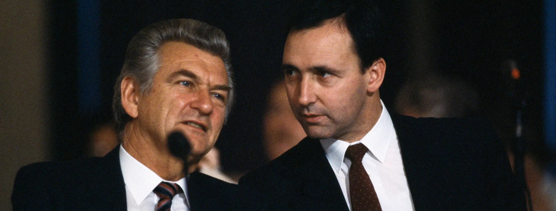 Prime Minister Bob Hawke and (future prime minister) Paul Keating sit behind a microphone at an Australian Labor Party conference.