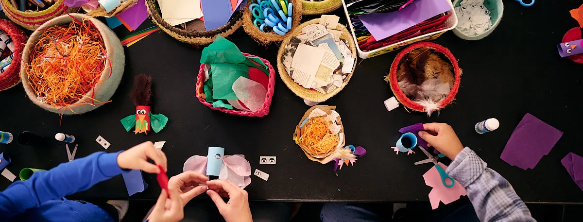 Kids and adults craft at a crafting table at Old Parliament House.