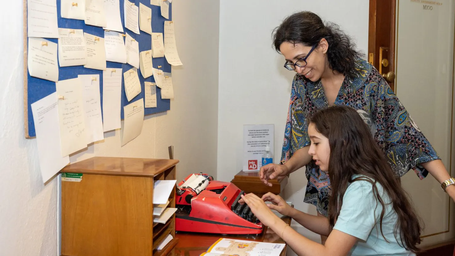 One visitor sat trying out a red typewriter while another watches