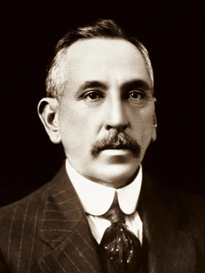 Portrait photograph of Billy Hughes, wearing a pin-striped suit.