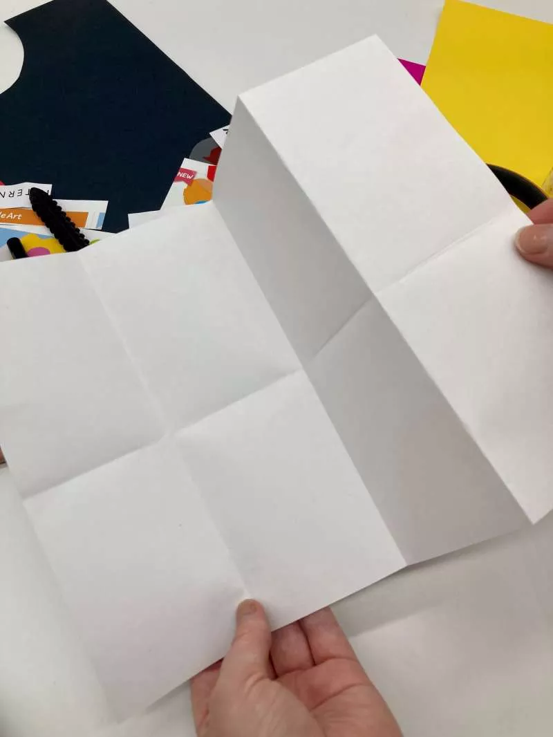 A piece of paper unfolded with creases indicating 8 sections. 