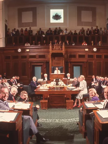 A colour photograph of the House of Representatives Chamber filled with seated politicians
