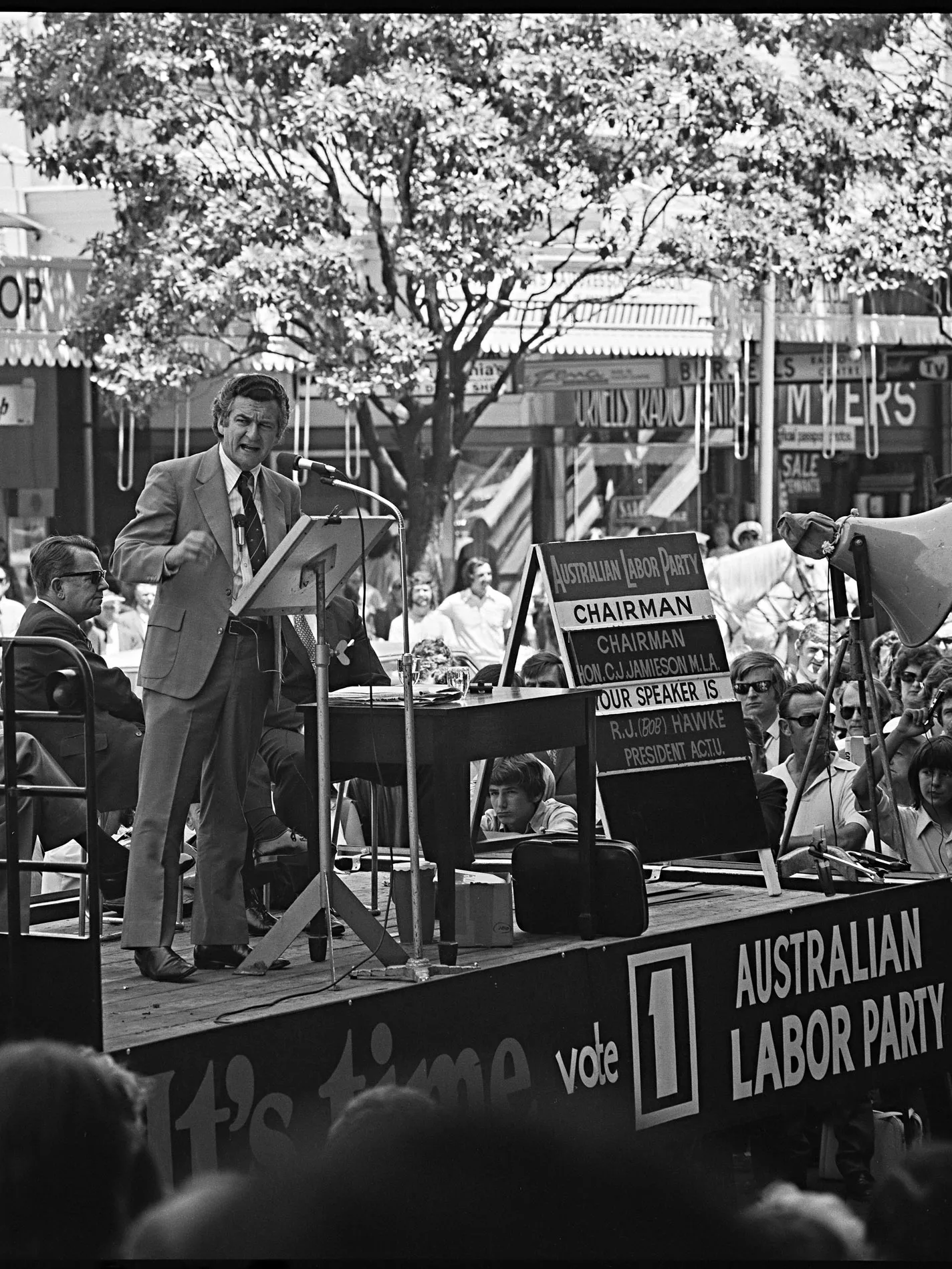 Bob Hawke speaks on an outdoor stage at a Labor Party campaign rally.