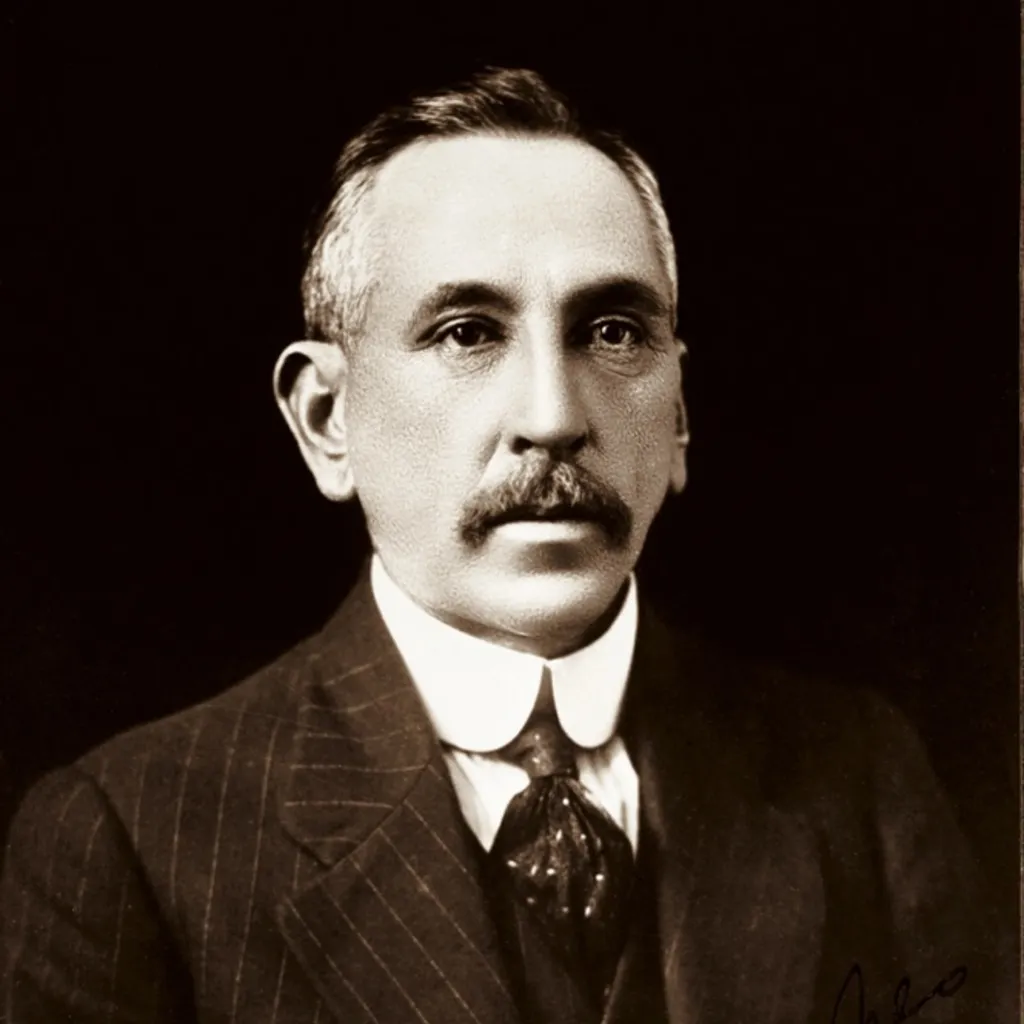 Portrait photograph of Billy Hughes, wearing a pin-striped suit.