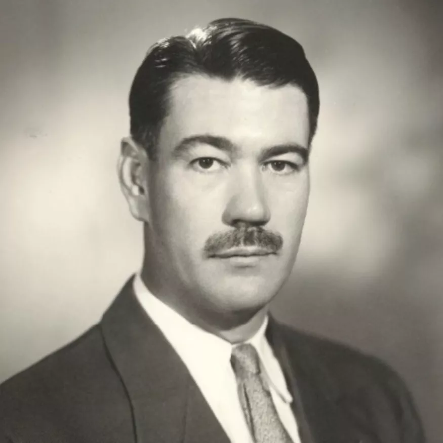 Portrait photograph of Sir Roden Cutler, wearing a suit and tie.