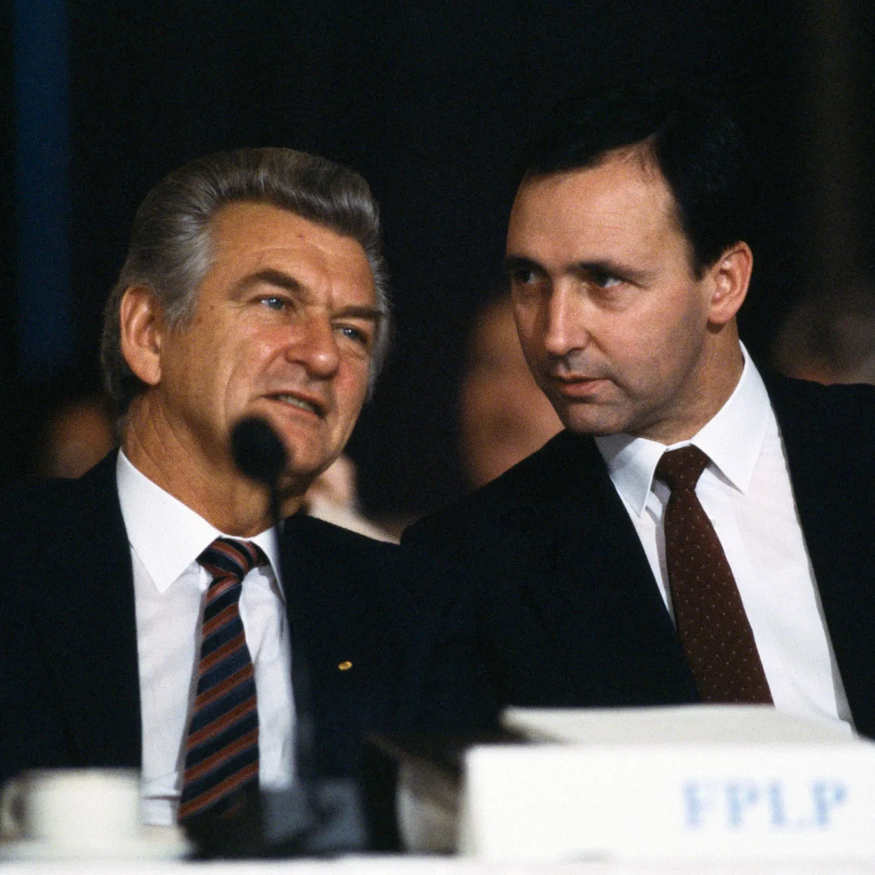 Prime Minister Bob Hawke and (future prime minister) Paul Keating sit behind a microphone at an Australian Labor Party conference.